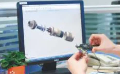 Engineer designing connector assembly at CAD workstation in R&D office