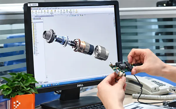 Engineer verifying connector and harness design at an engineering workstation
