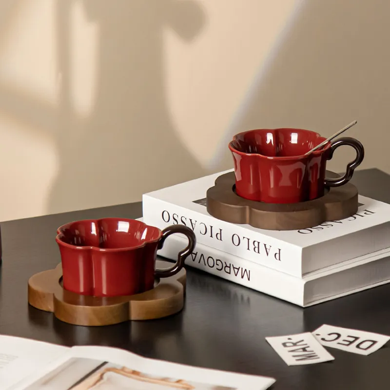 Vibrant Red Ceramic Mug with Contrasting Black Handle and Wood Coaster