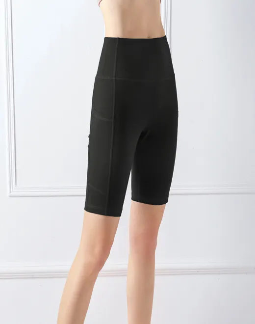 Pantalones cortos de entrenamiento ajustados 3/4 de damas con bolsillos laterales