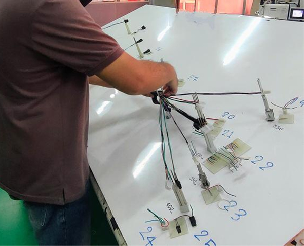 Technician assembling and testing custom moulded cable assemblies in the workshop