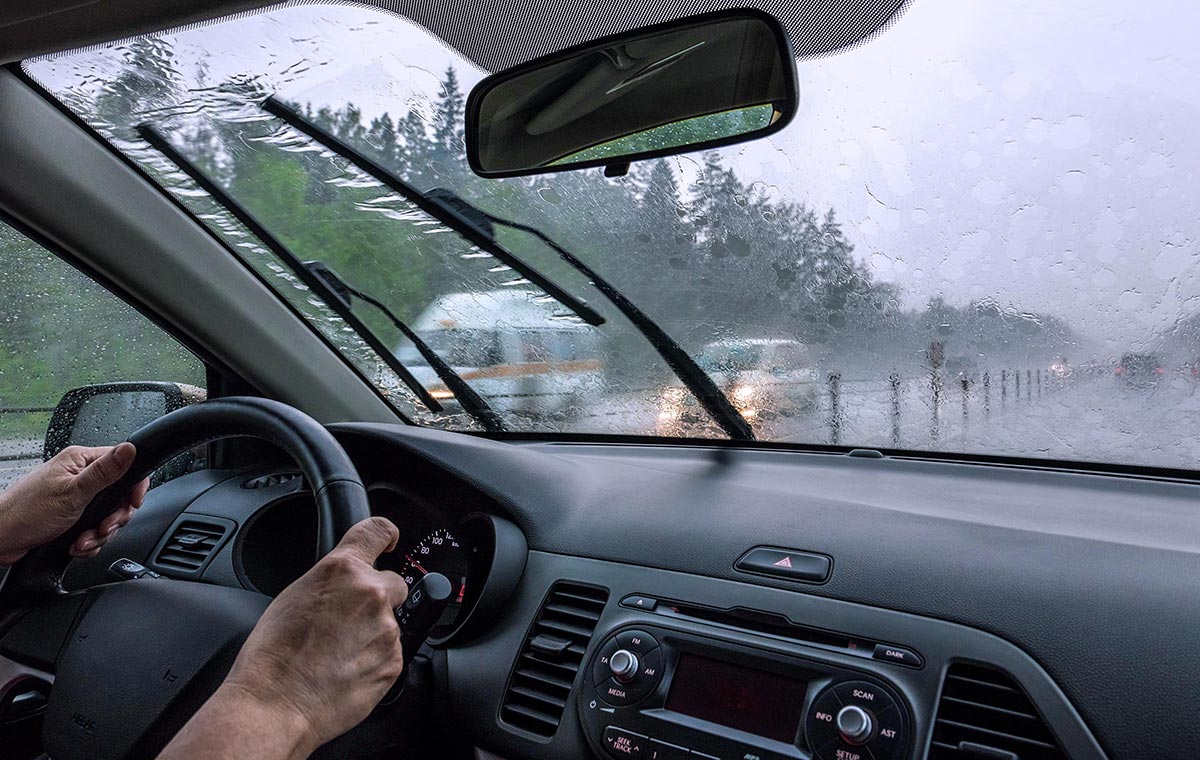 Car windshield wipers providing clear visibility during heavy rain