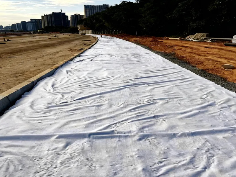 Load-bearing, durable, separation-enhancing, cost-effective road construction geotextile