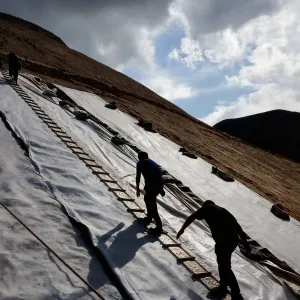 Weather-proof, impact-resistant, reinforced, long-life mining composite geomembrane