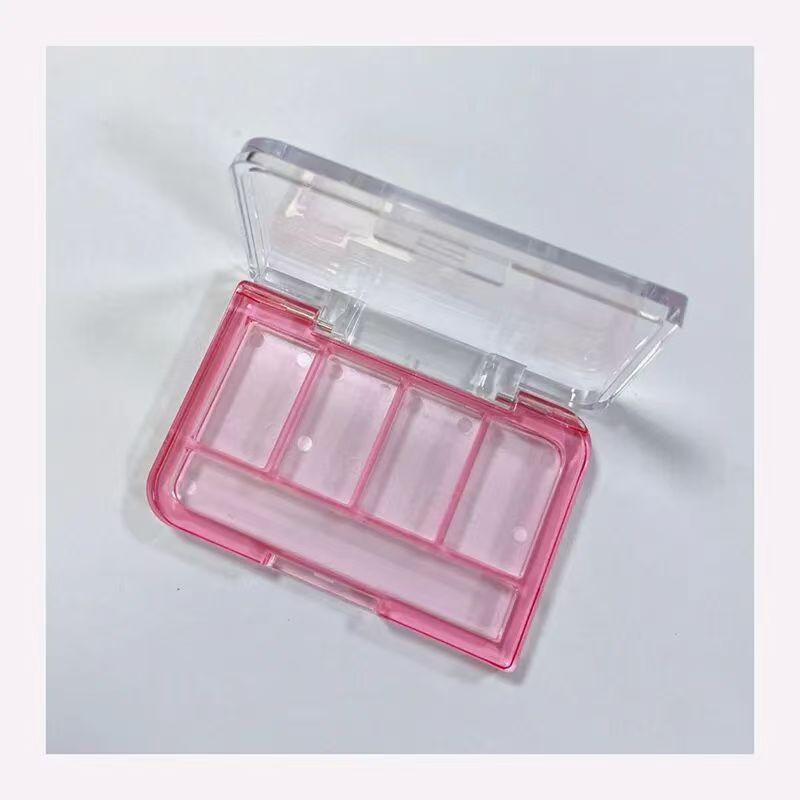 Four-color eyeshadow palette with brush holder.